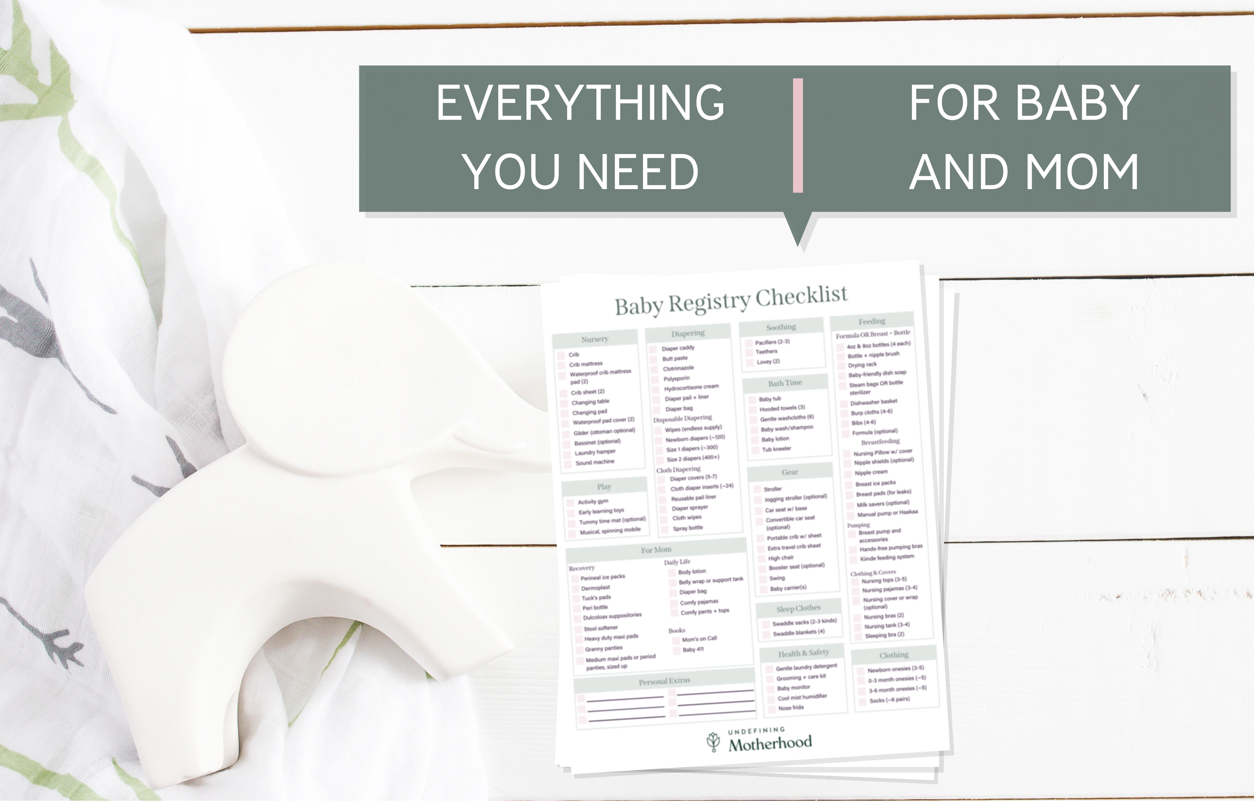 Paper copy of baby registry checklist on shiplap background with swaddle blanket and elephant