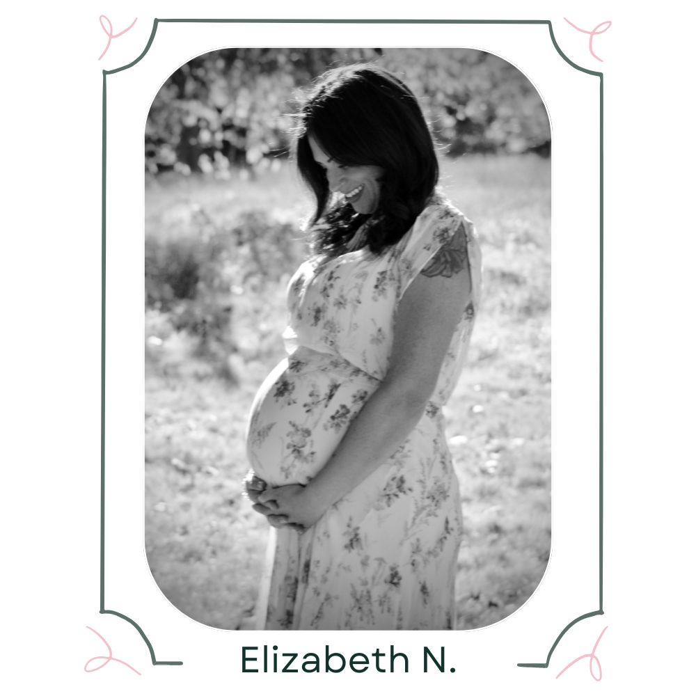 A photo of a woman standing in a field, looking down and smiling while cradling her pregnant belly in her arms. Underneath the photo is the name Elizabeth N